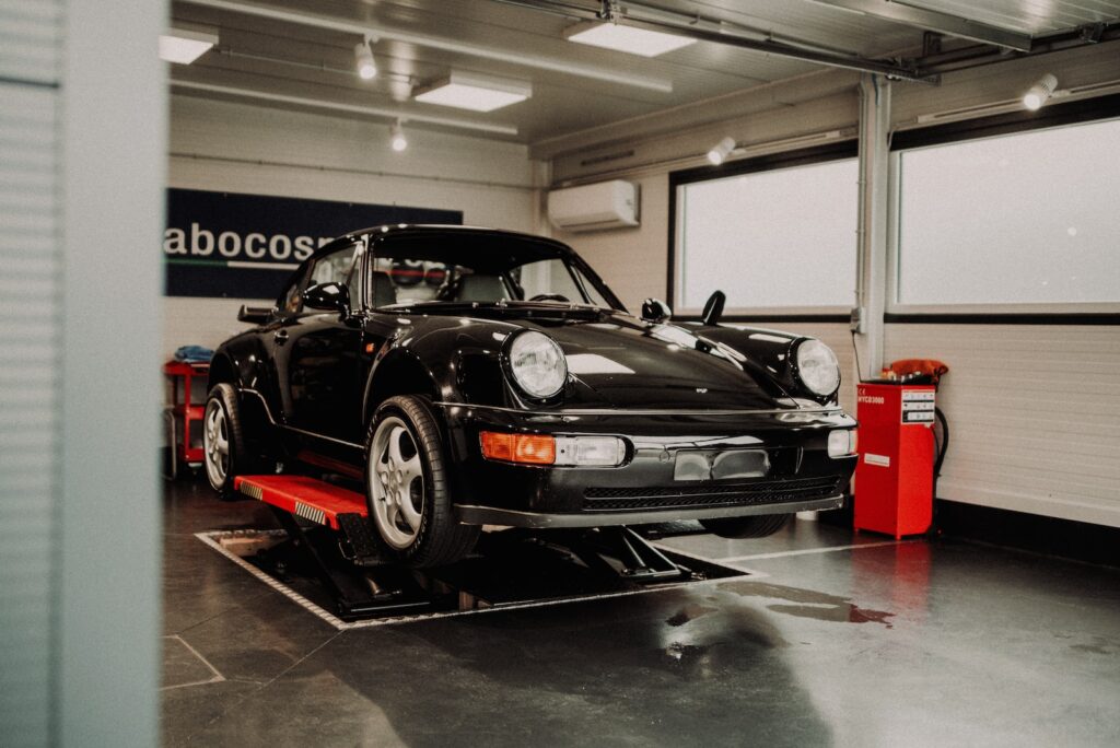 black porsche 911 parked in garage